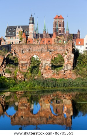 City of Gdansk (Danzig) in Poland, on the first plan ruins from the second World War with reflection on water