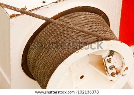 Drum and metal cable or hawser of a mechanical winch used for hoisting or hauling heavy loads