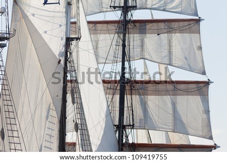 Marine or nautical background of a three masted barquentine yacht, square rigged on the foremast, with sails and rigging detail
