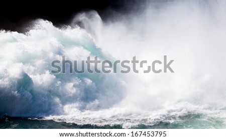 Dramatic background image of crashing wall of flood water stream breaking with flying spray