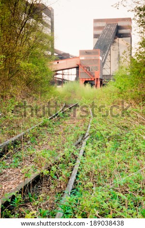 Overgrown railway access to shut down underground coal mine in Essen, Germany, Europe