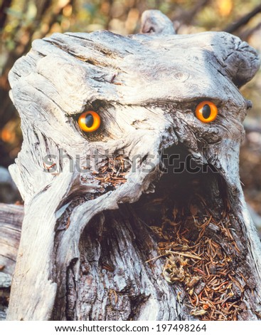 Funny forest fantasy root angry looking troll chimera with sparkling orange eyes