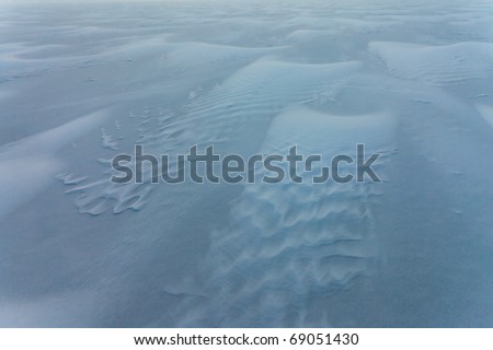 Windswept snowscape of drifting powder snow.