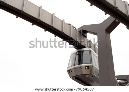 Modern public transportation system Sky-Train hanging from elevated guide way beam on columns isolated on white background