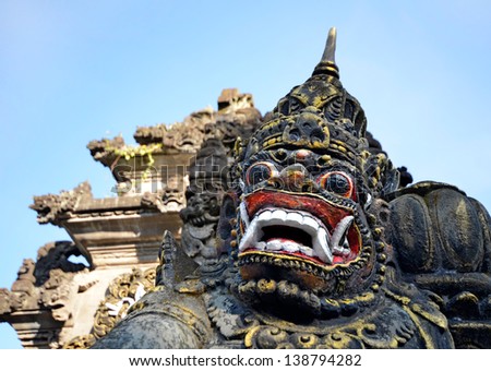 Scary stone barong mask at entrance to Tanah Lot, Bali Indonesia