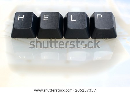 IT HELP - Four Black Keyboard Keys reading word help on White Glass Background