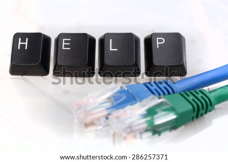 IT HELP - Four Black Keyboard Keys reading word HELP with Blue and Green Network Cables on White Glass Background