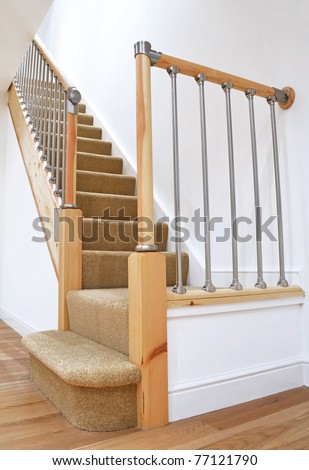 Modern House Interior -  Typical UK British Stairs with Chrome Railing with Beige Carpet. Looking up