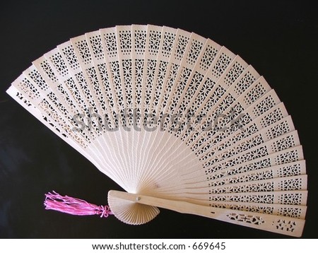 Cutout wooden oriental fan on black