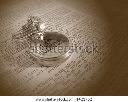 stock photo Sepia tone wedding rings on bible