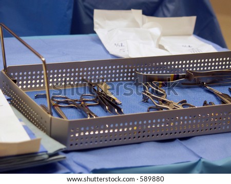 surgical instruments in tray on sterile drape