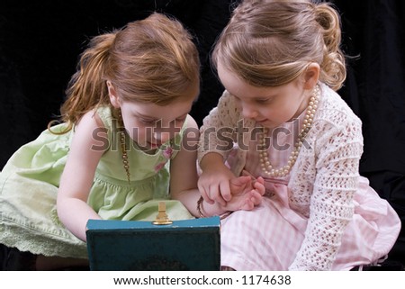 Little girls exploring old jewelry box