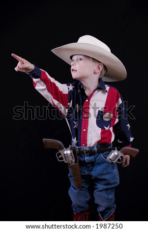 Little five year-old cowboy pointing his finger.