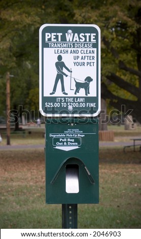 Sign at dog park encouraging proper pet waste disposal.