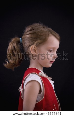 Profile of a beautiful little girl in a cowgirl outfit.