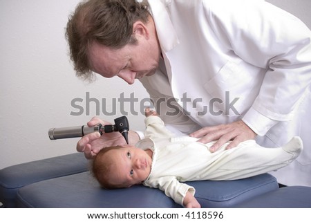 Pediatrician performing a physical exam on a healthy newborn.