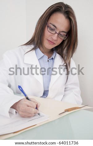 Young female doctor working on a patient chart