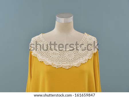 female yellow dress mannequin isolated on blue background