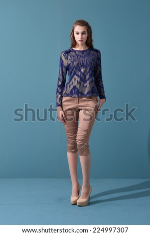 full-length portrait of casual fashion woman standing in studio
