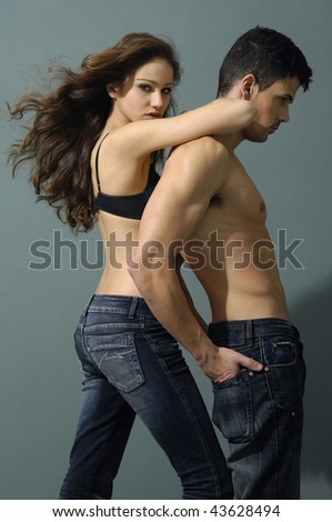 Sexy couple model against gray