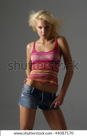 Young sexy woman in jeans shot in studio