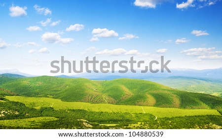 Bright mountains  hills. Bright sky and clouds