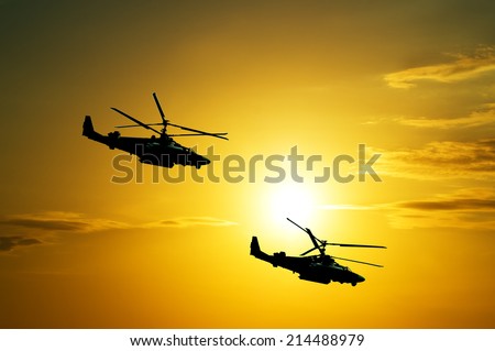 Helicopters at sunset in the sky