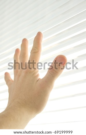 The human hand touches to window