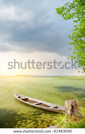 Boat at coast against a coming nearer thunder-storm