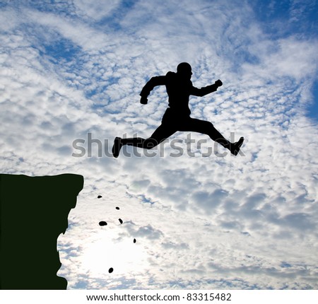 jumping man against blue sky.
