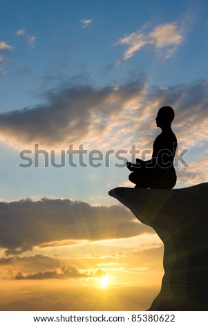 sunset meditation.silhouette of man.