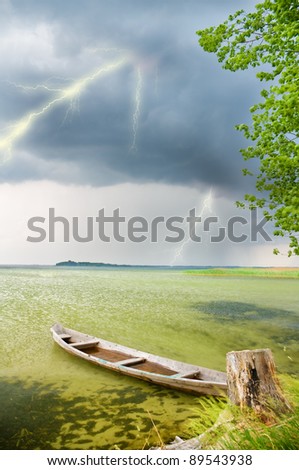 Boat at coast against a coming nearer thunder-storm