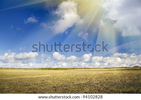 brown clay soil field blue sky horizon