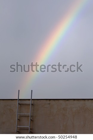 rainbow shot with ladder where the rainbow seems to start where the ladder finishes