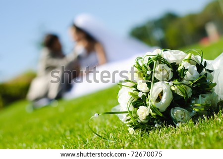 stock photo bridal bouquet of white roses on a green meadow and blurred 