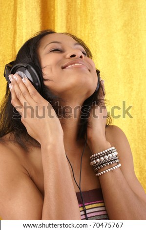 young female listens to her favorite song on her earphones.