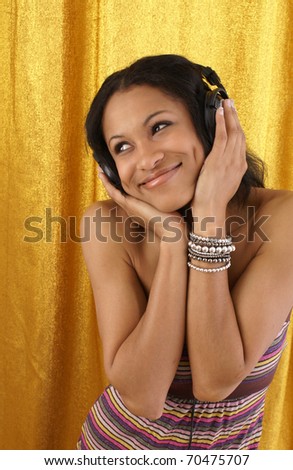 young female listens to her favorite song on her earphones.