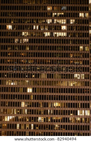 Windows lit up in an office building at night.