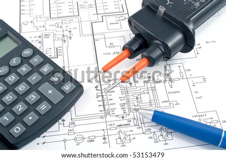 Voltage tester,calculator and pen on electrical diagram