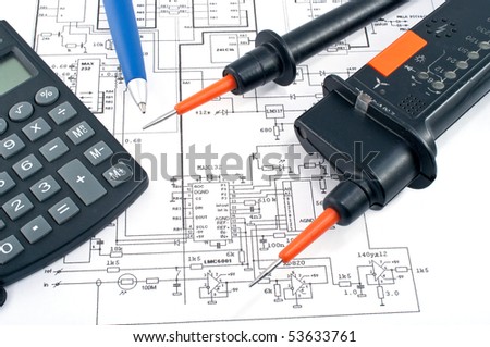 Voltage tester,calculator  and pen on electrical diagram