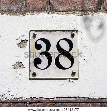 stock-photo-house-number-thirty-eight-black-lettering-behind-a-transparent-plastic-frame-103412177.jpg