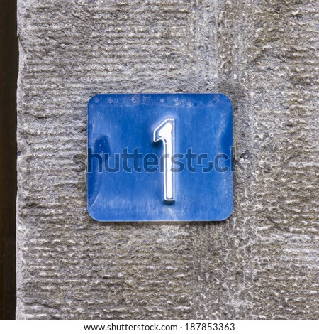 house number one, embossed in a blue metal plate