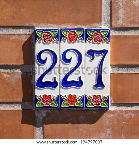 ceramic house number two hundred and twenty seven on three tiles