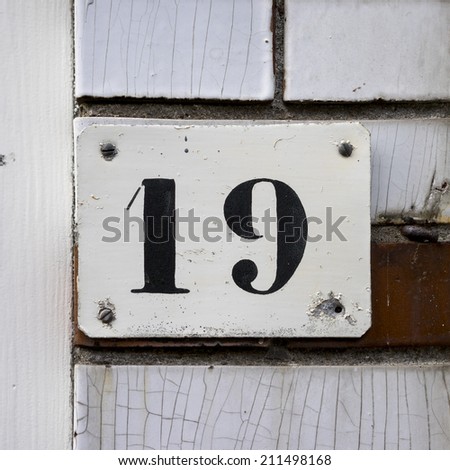house number nineteen. Black template lettering