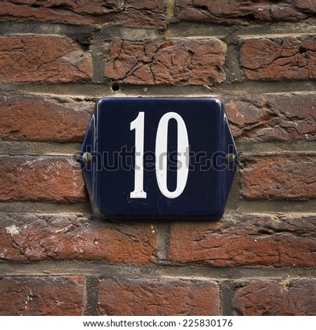 enameled house number ten. white lettering on a blue background