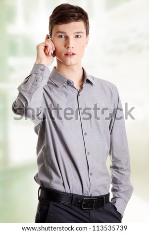 Young businessman calling by mobile phone.