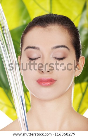 Portrait of beautiful clean face of woman under the stream of water