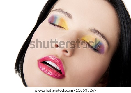 Beautiful woman with rainbow eye make up, isolated on white