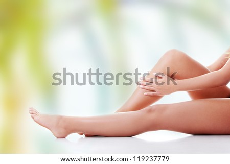 Woman holding on leg.