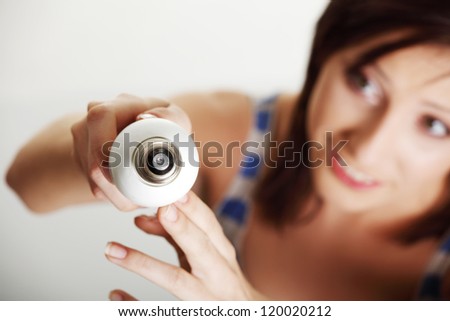 Young woman changing a light bulb , isolated